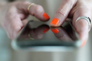 Frau tippt auf einem Smartphone