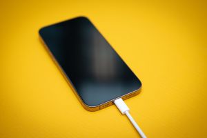 Ein iPhone mit schwarzem Bildschirm an einem USB-C-Kabel